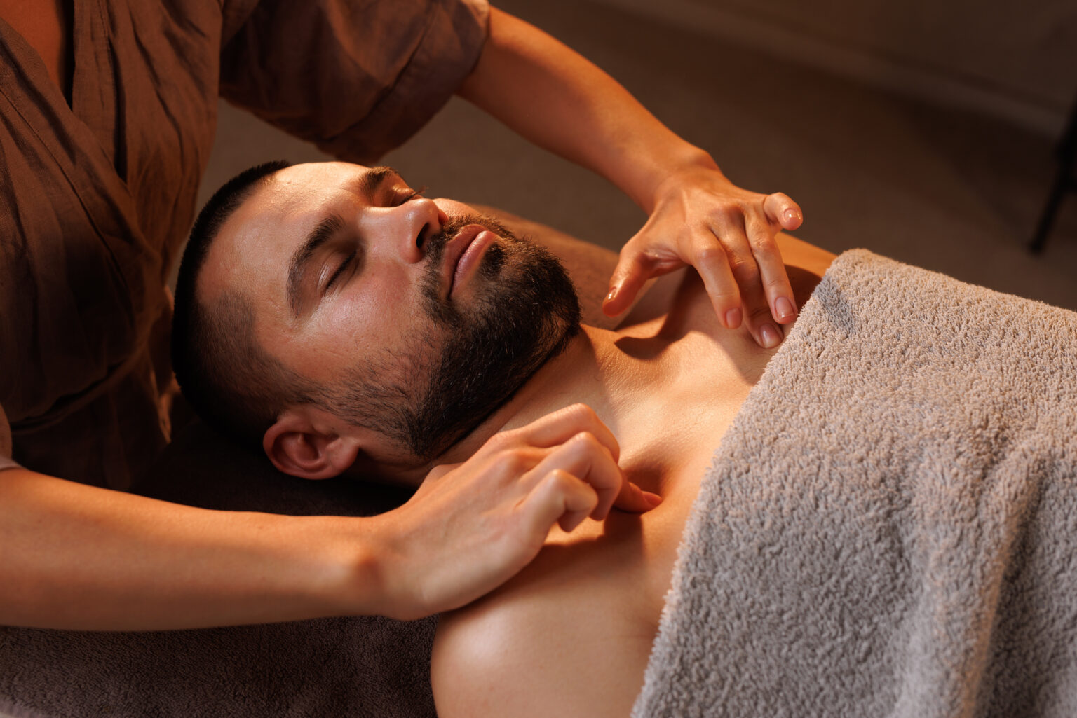 Man gets chest massage in spa enjoying relaxing a